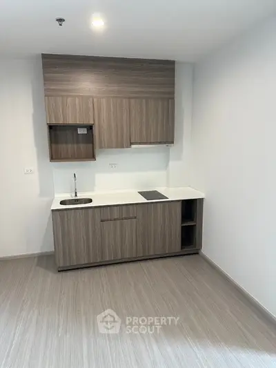 Modern compact kitchen with sleek wooden cabinets and minimalist design