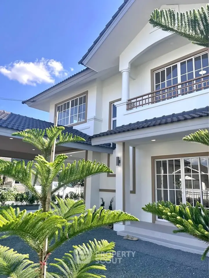 Stunning two-story house with modern architecture and lush greenery, perfect for family living.