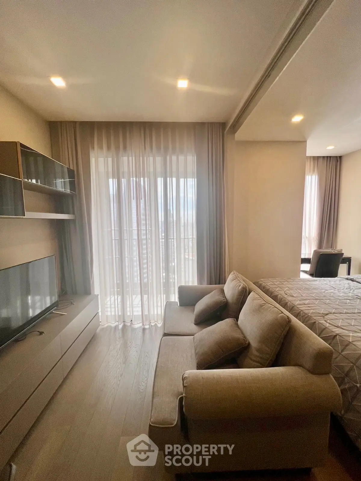 Modern living room with cozy sofa and large window offering natural light