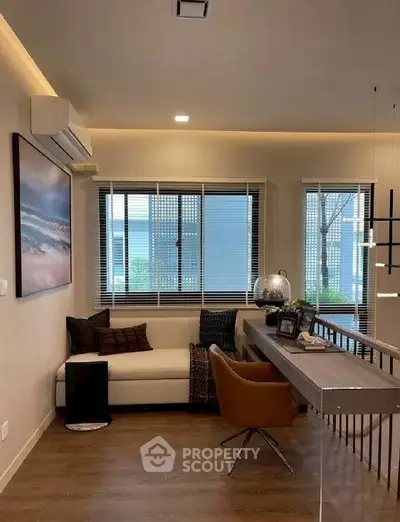 Modern living room with stylish decor and large windows offering natural light