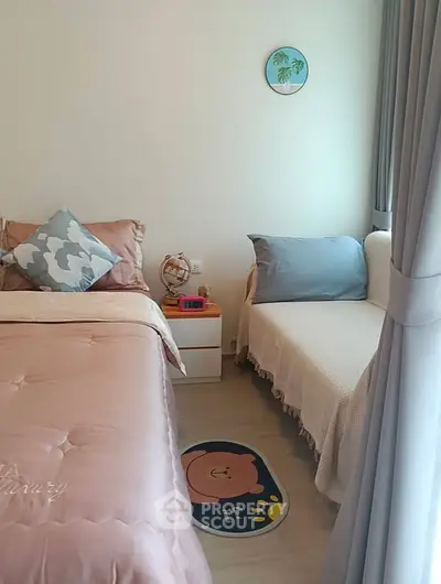 Cozy bedroom with stylish decor and natural light, featuring a comfortable bed and a charming seating area.