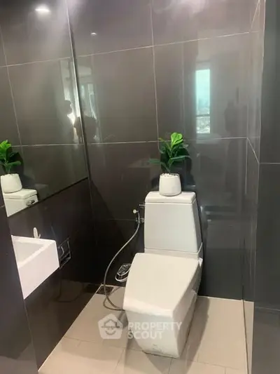 Modern bathroom with sleek tiles and stylish toilet design