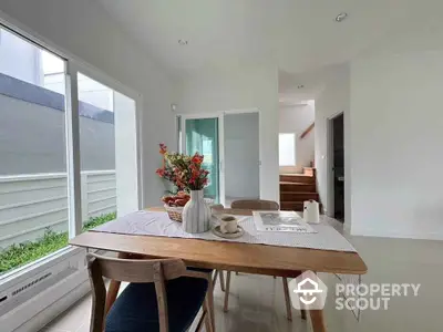 Bright dining area with modern decor and large windows in a contemporary home