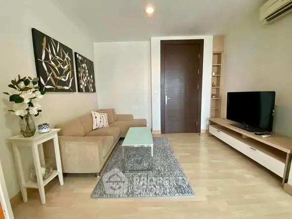 Modern living room with stylish decor, cozy sofa, and sleek entertainment unit in a contemporary apartment.