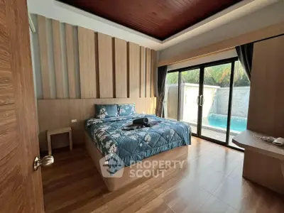 Luxurious bedroom with pool view and modern wooden interior design