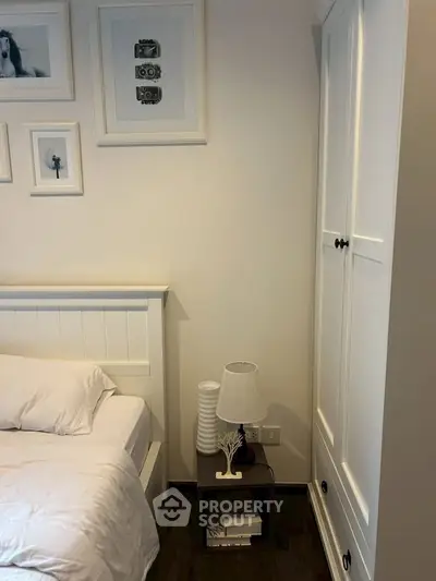 Cozy bedroom with white furniture and elegant decor, perfect for relaxation and comfort.