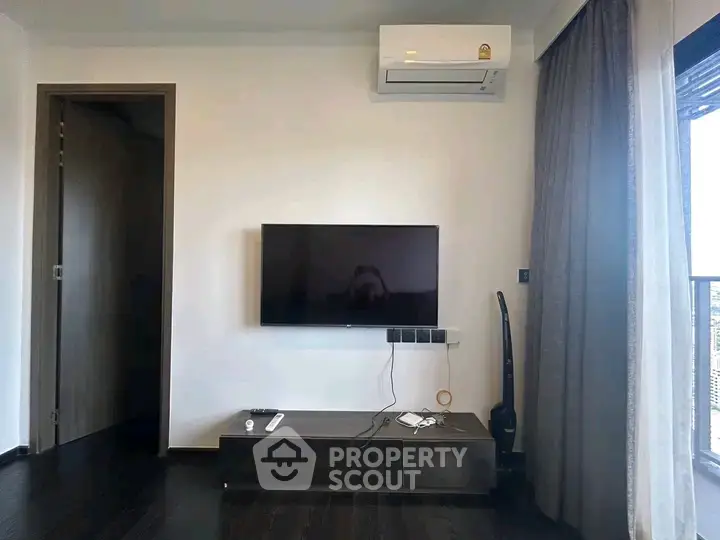 Modern living room with wall-mounted TV and air conditioning unit