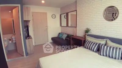 Modern studio apartment with stylish decor and cozy ambiance, featuring a comfortable bed and chic furnishings.