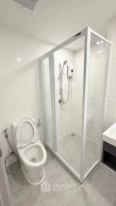 Modern bathroom with glass shower enclosure and sleek fixtures