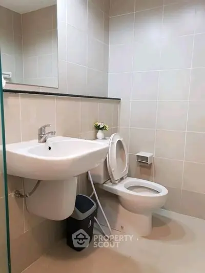 Modern bathroom with sleek fixtures and neutral tiles