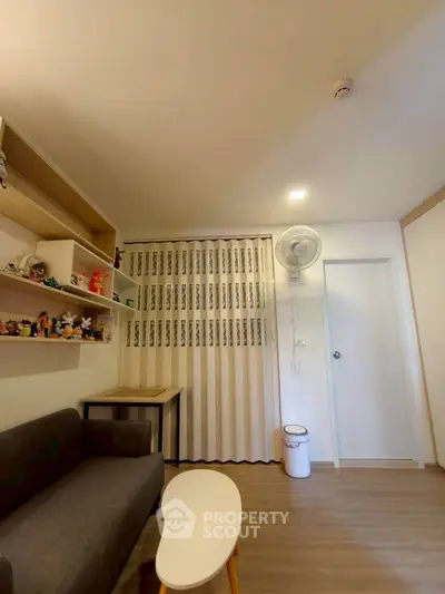 Cozy living room with modern decor and shelving, featuring a comfortable sofa and stylish coffee table.