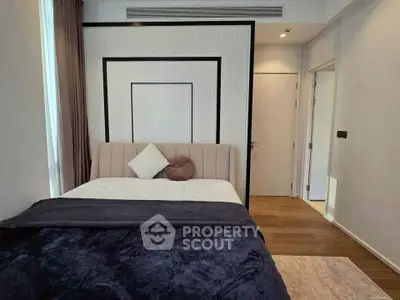 Modern bedroom with stylish decor and cozy bedding in a contemporary apartment.