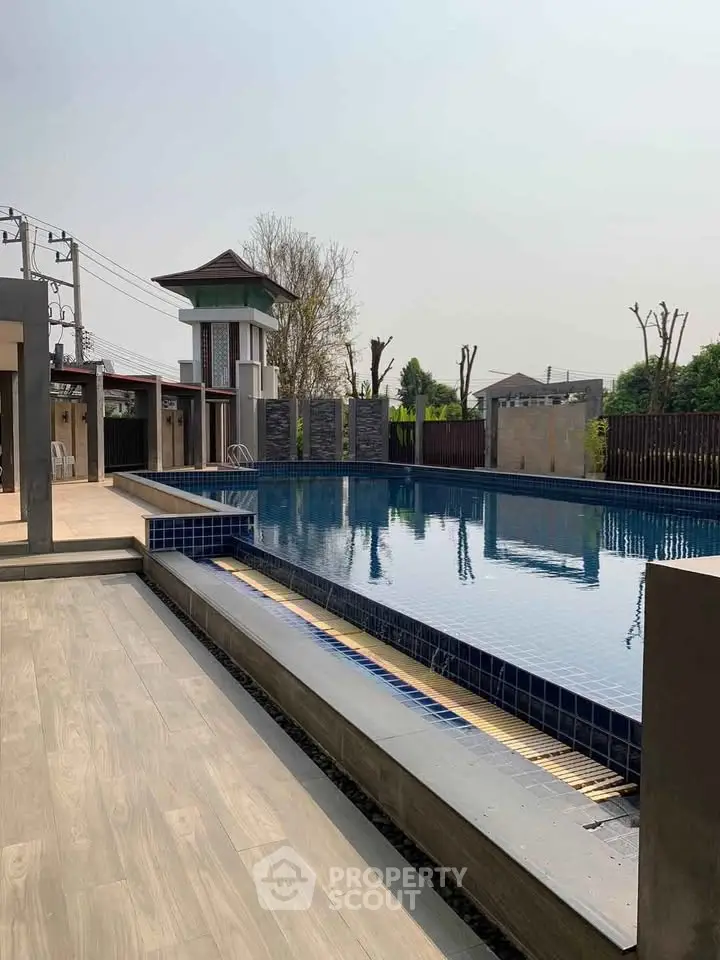 Luxurious outdoor pool area with modern design and serene surroundings.