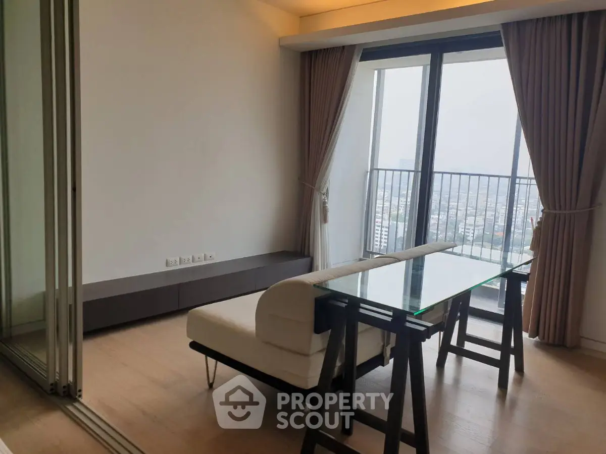 Modern living room with glass table and city view balcony, elegant curtains and wooden flooring.