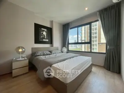 Modern bedroom with large window and stylish decor in urban apartment