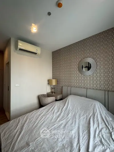 Modern bedroom with stylish wallpaper and air conditioning unit, featuring cozy lighting and elegant decor.