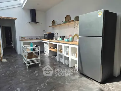 Spacious modern kitchen with sleek appliances and open shelving, perfect for culinary enthusiasts.