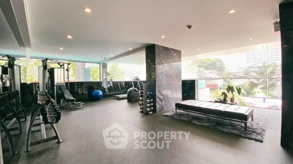 Spacious modern gym with state-of-the-art equipment and panoramic windows.