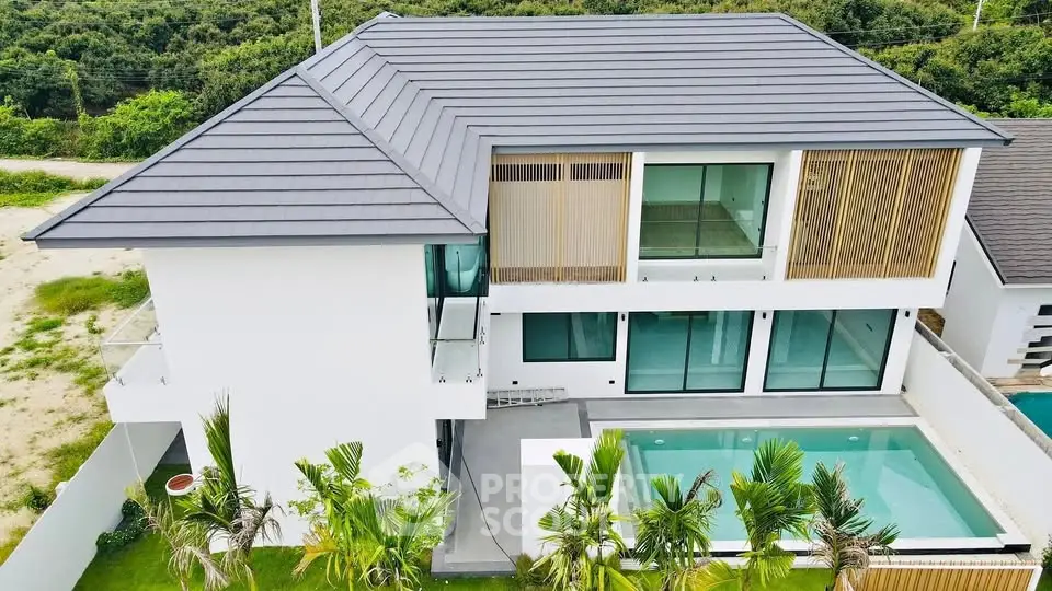 Luxurious modern villa with private pool and lush greenery, perfect for serene living.