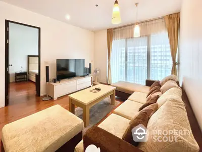 Spacious living room with modern decor and large windows in a stylish apartment