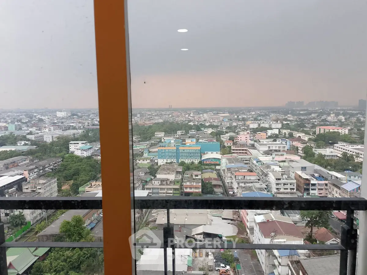 Stunning cityscape view from high-rise balcony with expansive skyline.