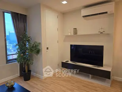 Modern living room with sleek TV setup and city view window
