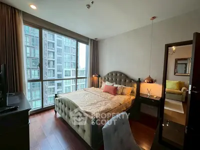 Luxurious bedroom with modern decor and large window offering city view