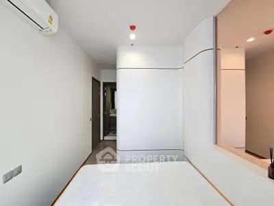 Modern minimalist bedroom with sleek design and white walls