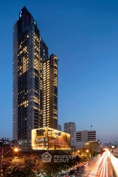 Stunning high-rise building with modern architecture and vibrant city lights at dusk.