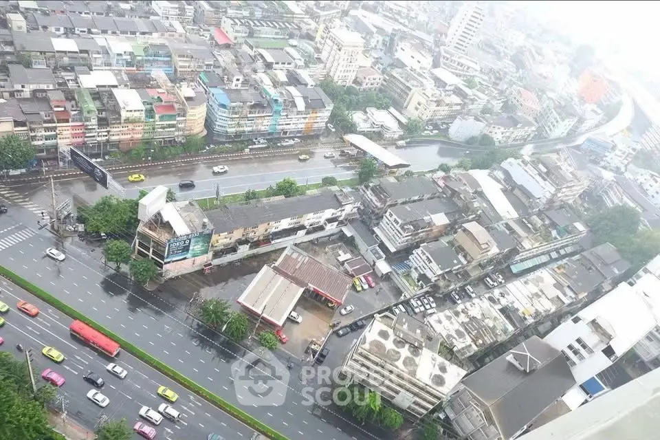 Aerial view of urban cityscape with roads and buildings on a rainy day.