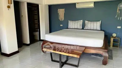Spacious bedroom with elegant wooden bed and modern decor