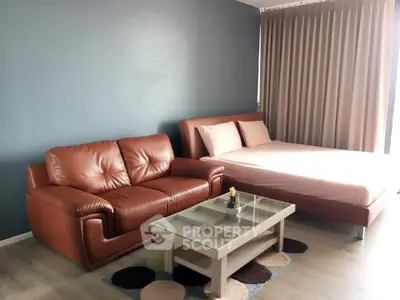 Modern bedroom with stylish leather sofa and cozy bed in a chic apartment.