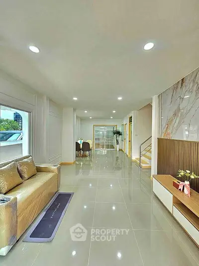 Spacious modern living room with elegant decor and ample natural light.