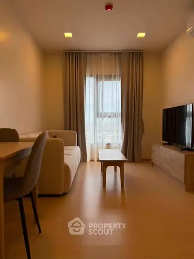 Modern living room with cozy sofa, TV, and dining area, featuring warm lighting and elegant curtains.