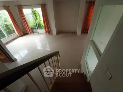 Spacious living room with large windows and natural light