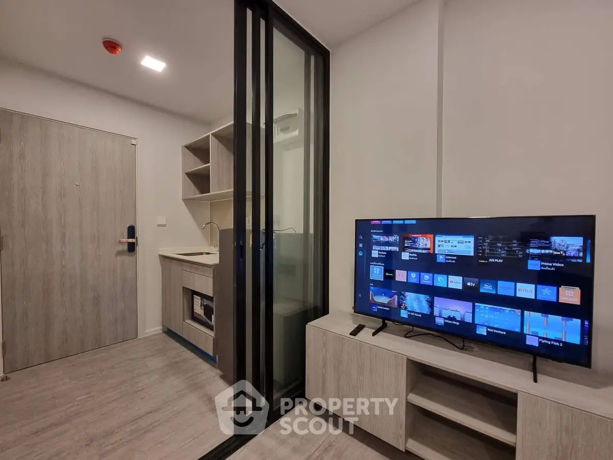 Modern apartment interior with sleek kitchen and entertainment area