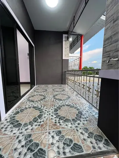 Spacious balcony with decorative tiles and elegant railing, perfect for relaxation and enjoying views.