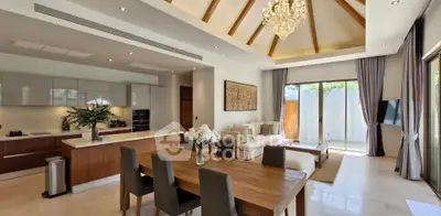 Luxurious open-plan living room with high ceilings and elegant chandelier in modern home.