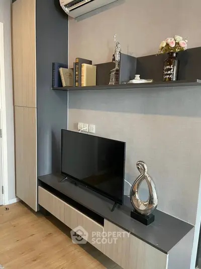 Modern living room with stylish TV unit and decorative shelves