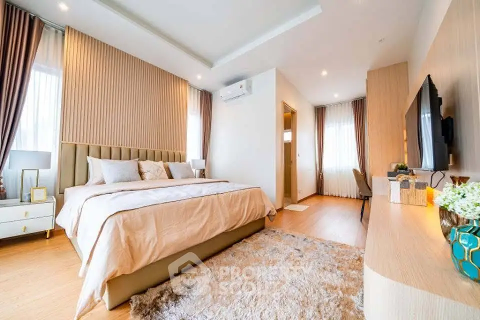 Luxurious bedroom with modern decor and plush carpet in a stylish home.