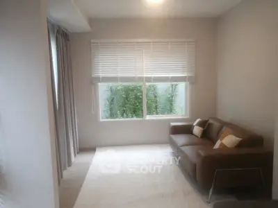 Cozy living room with modern sofa and large window view