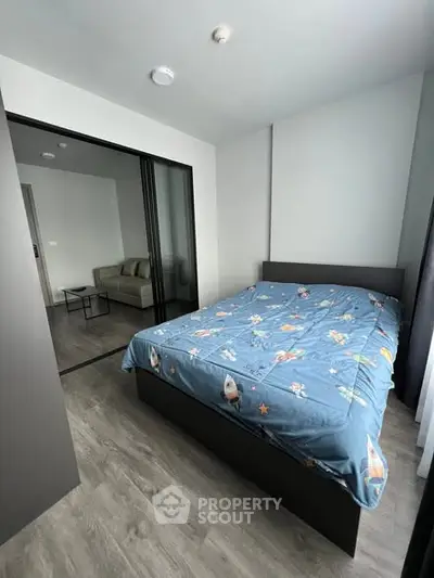 Modern bedroom with sliding glass doors and cozy decor