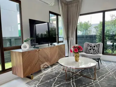 Modern living room with stylish furniture, large windows, and elegant decor in a bright, airy space.