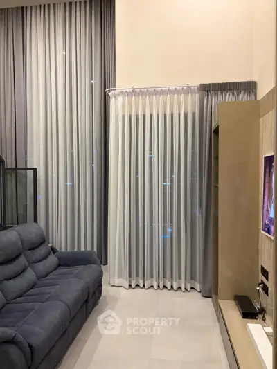 Modern living room with elegant curtains and cozy sofa in stylish apartment