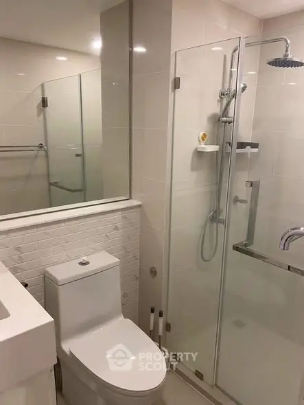 Modern bathroom with glass shower and sleek fixtures