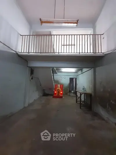 Spacious industrial-style interior with high ceiling and mezzanine level