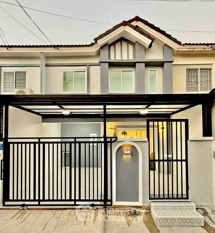 Charming two-story house with modern facade and gated entrance