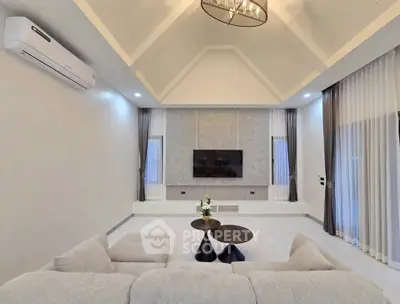 Spacious modern living room with vaulted ceiling and elegant decor