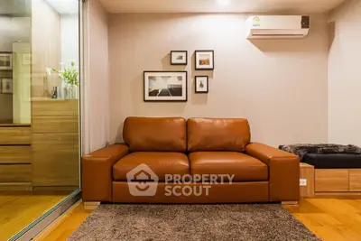 Cozy living room with brown leather sofa and modern decor