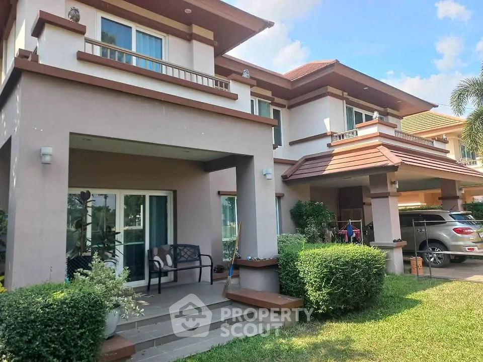 Charming two-story house with lush garden and carport in a serene neighborhood.